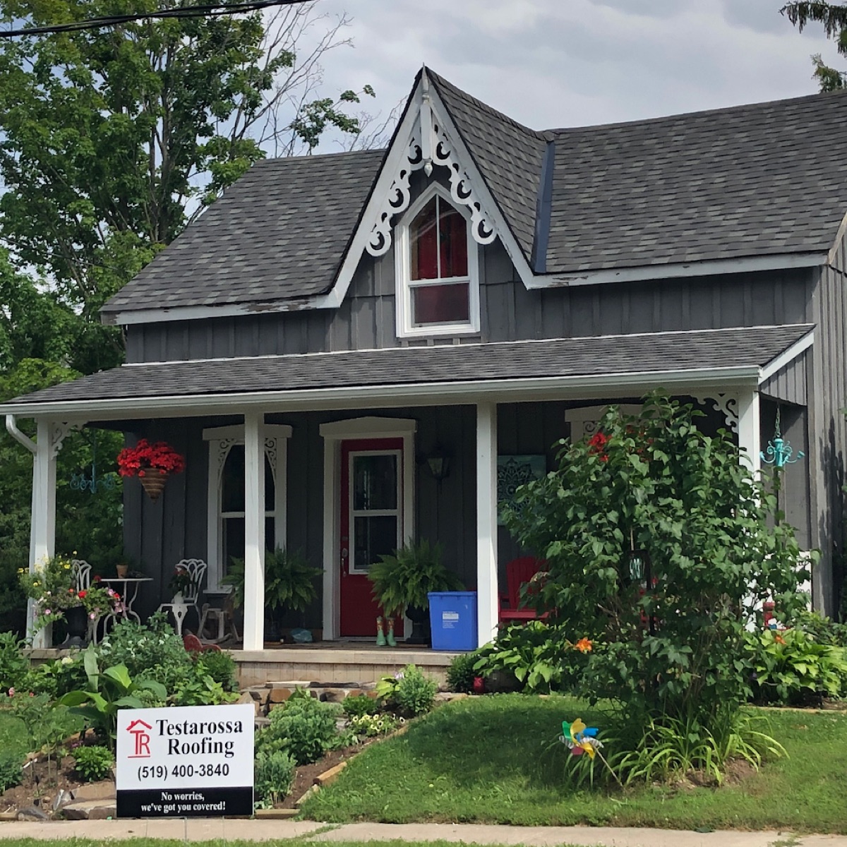 Finished Victorian farmhouse in Hillsburgh with a new grey asphalt shingle roof and gingerbread trim